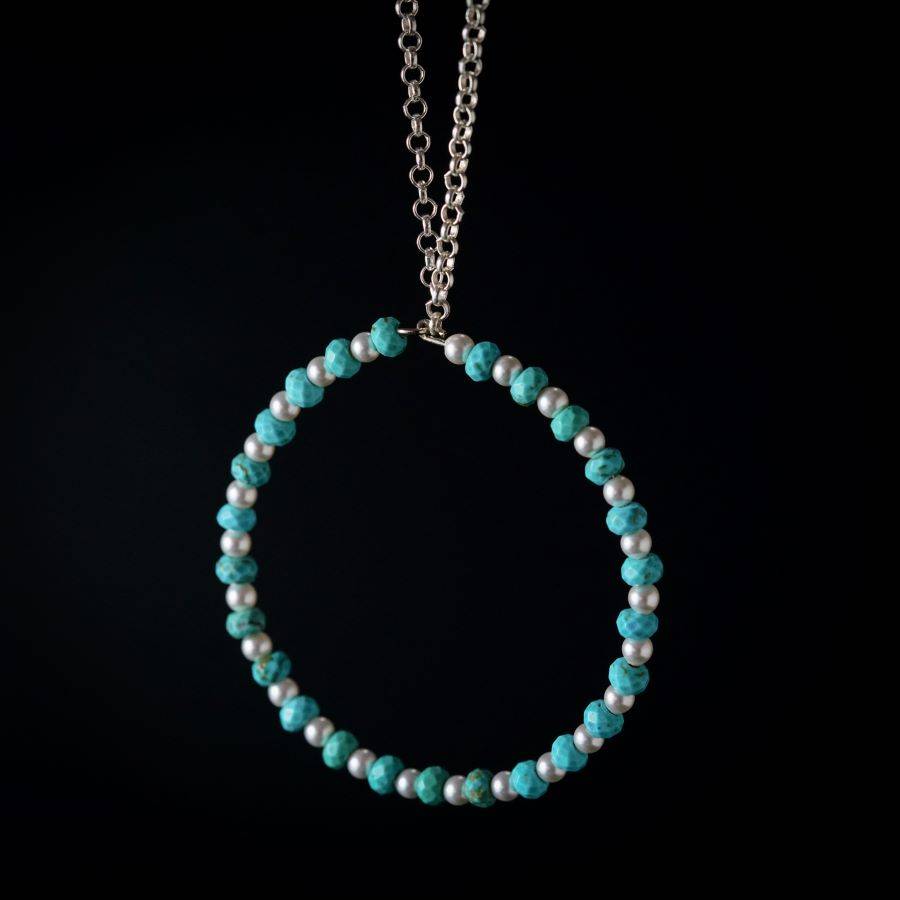 a blue beaded bracelet with a silver chain