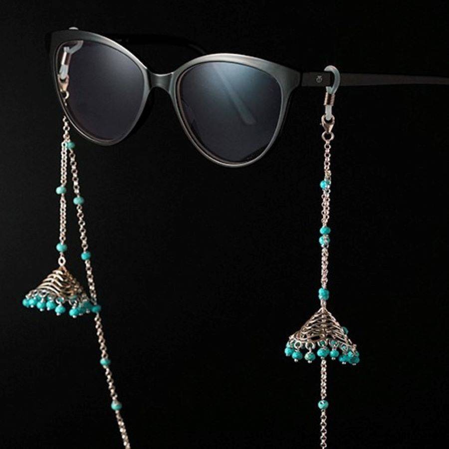 a pair of sunglasses hanging from a pair of chain