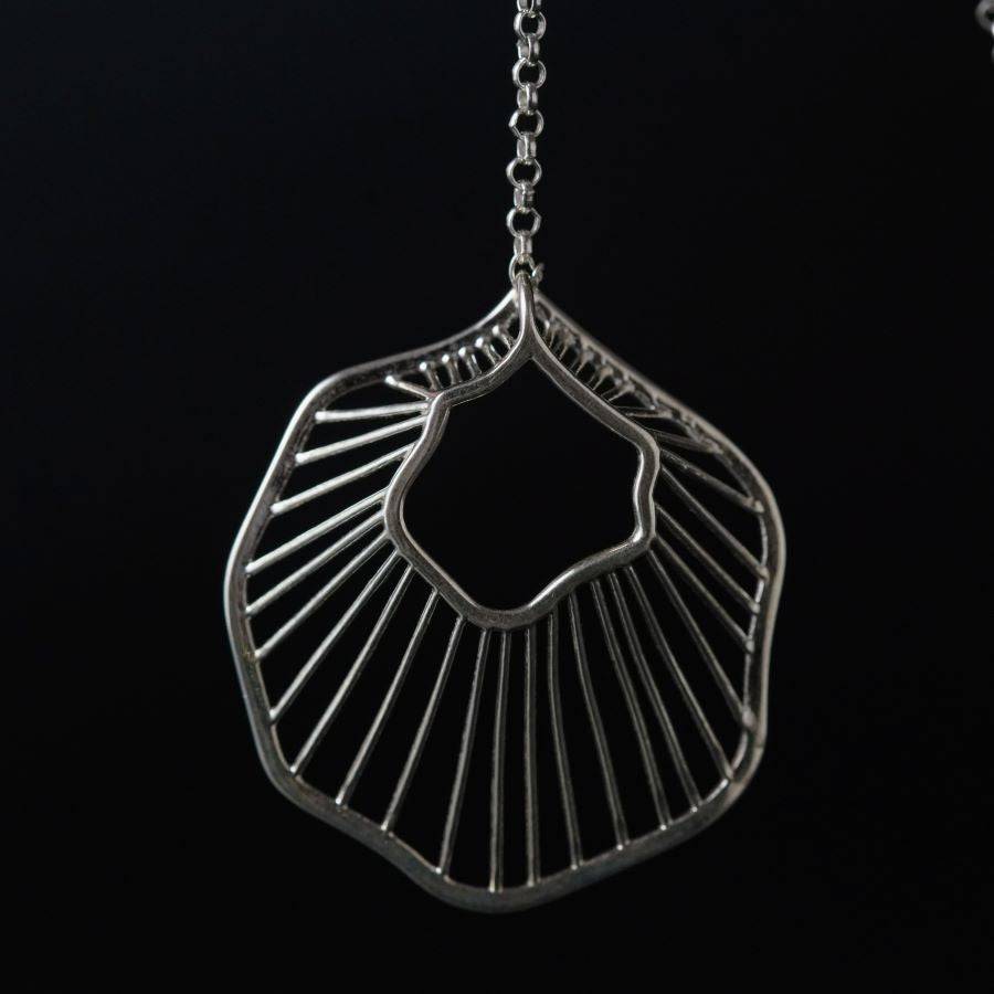 a close up of a metal object on a chain