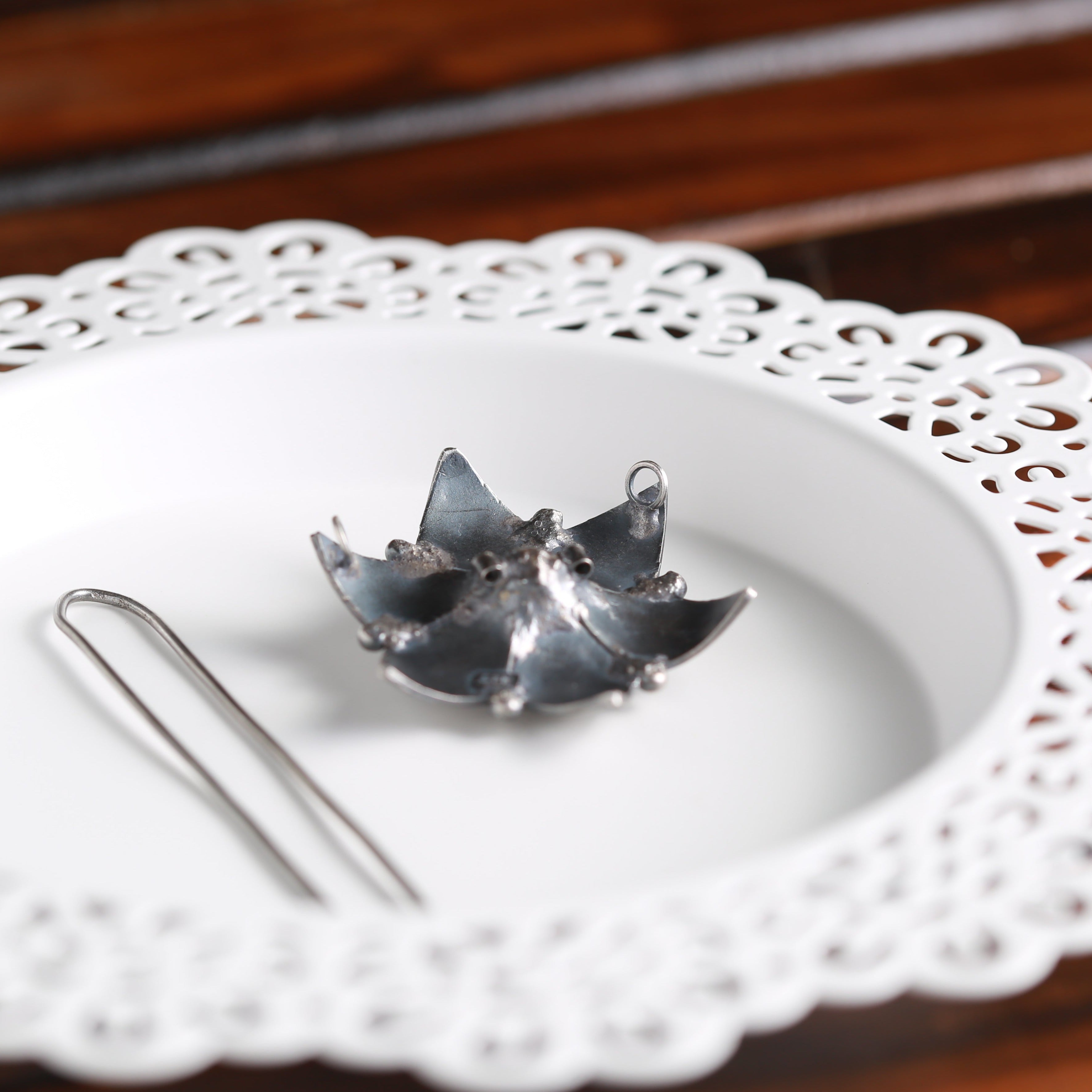 a white plate topped with a metal object