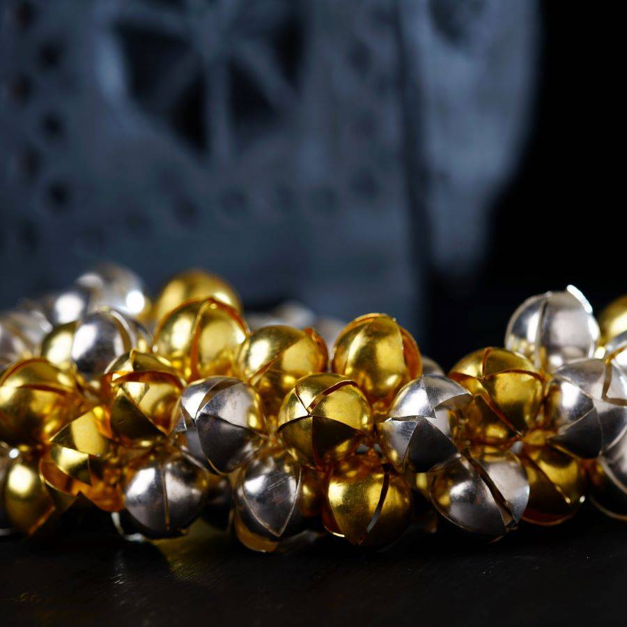 a bunch of gold and silver bells on a table