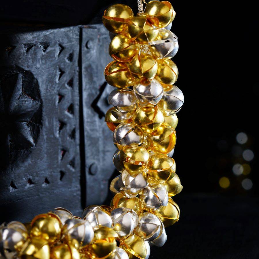 a bunch of gold and silver bells hanging from a chain