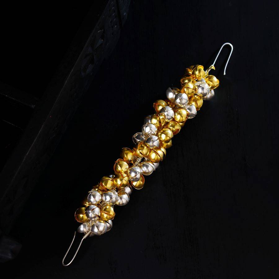 a close up of a pair of earrings on a black surface