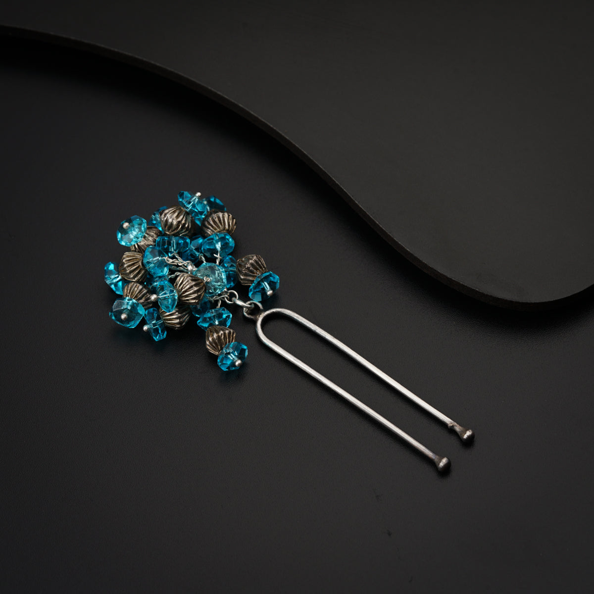 a bunch of beads sitting on top of a black table