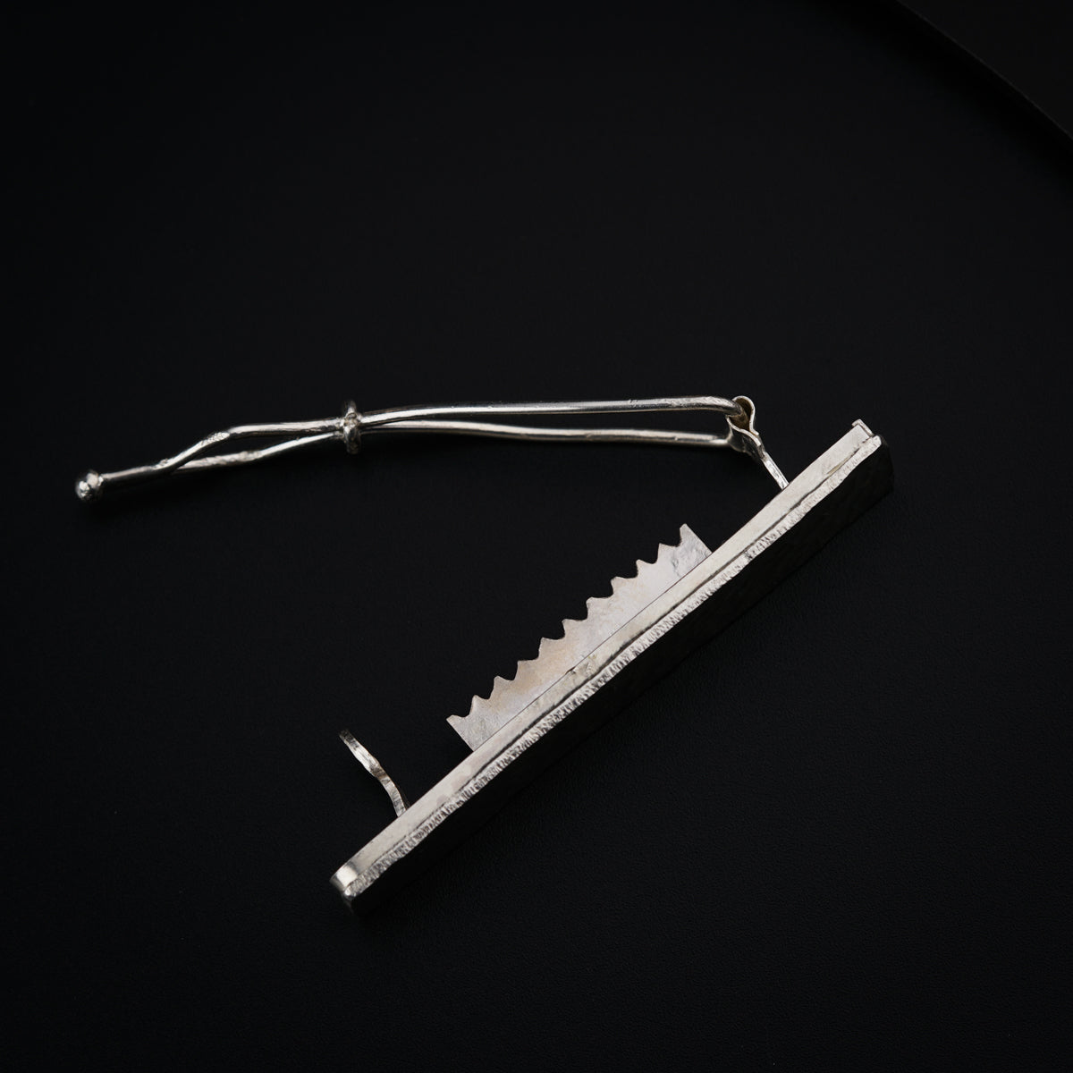 a razor blade laying on top of a black surface