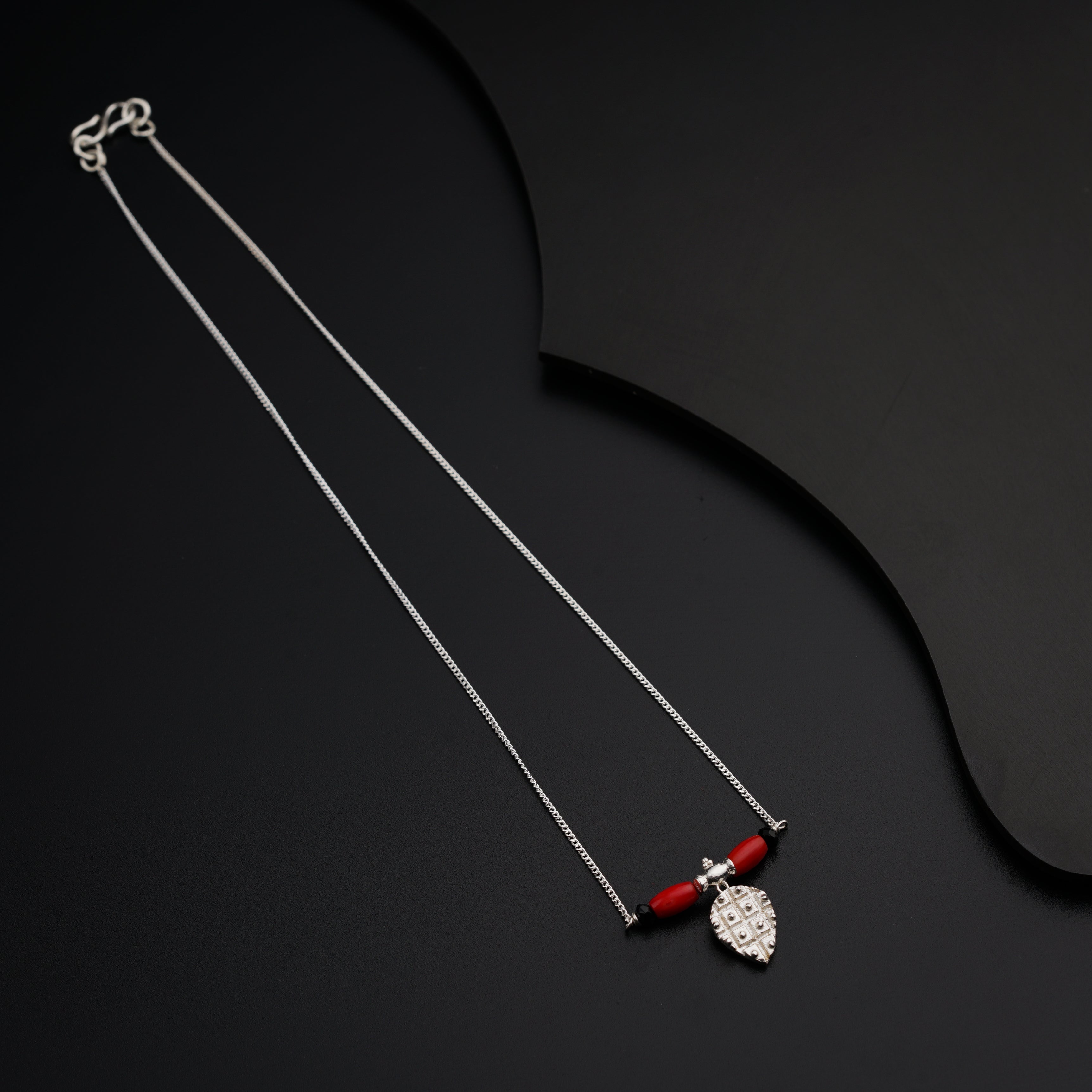 a couple of necklaces sitting on top of a table