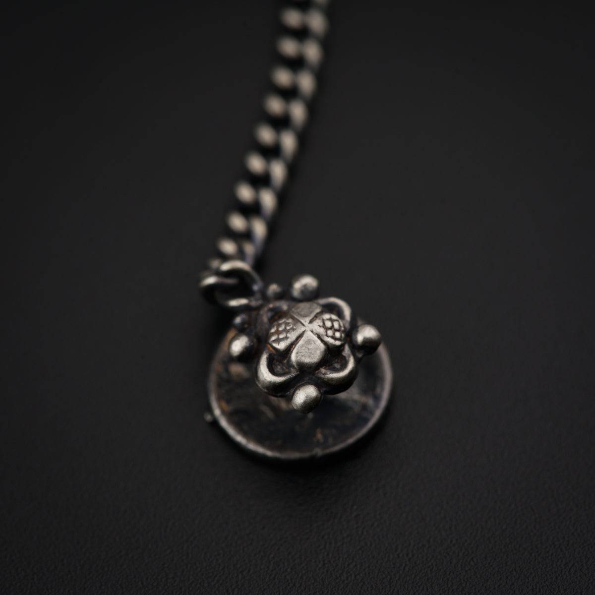 a necklace with a four leaf clover on it