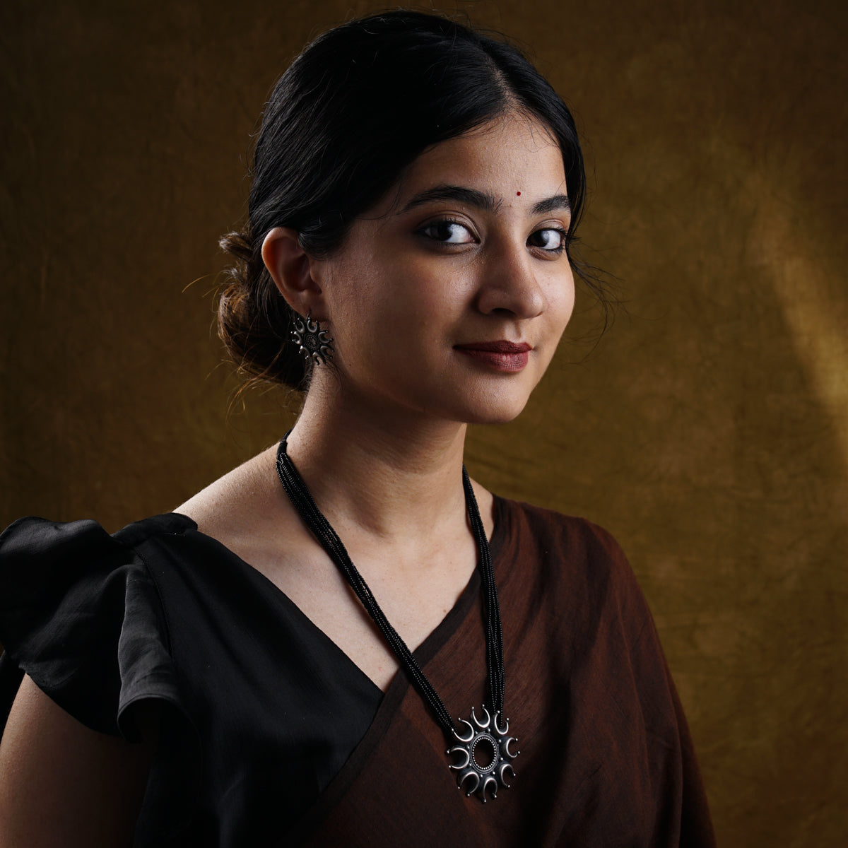 a woman with a necklace on her neck