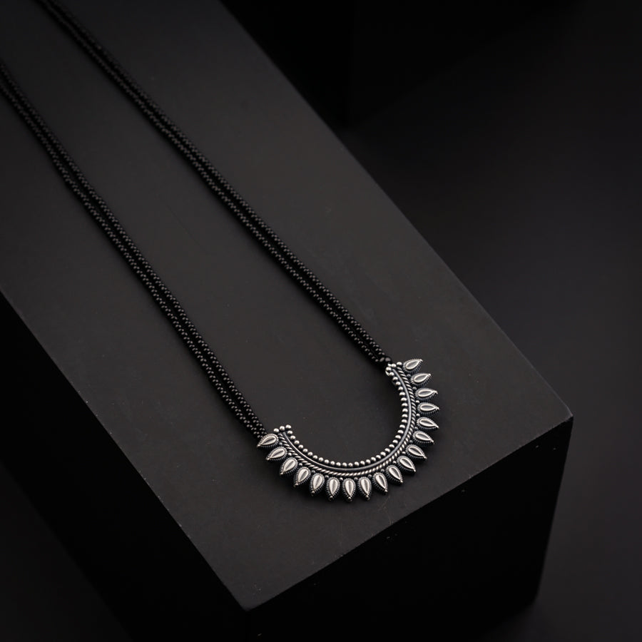 a black box with a necklace on top of it