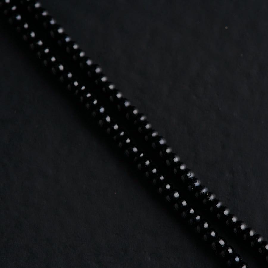 a close up of a black beaded cord