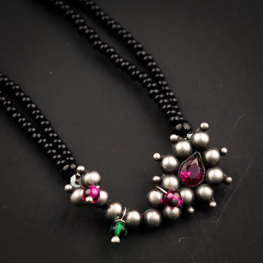 a close up of a necklace on a table