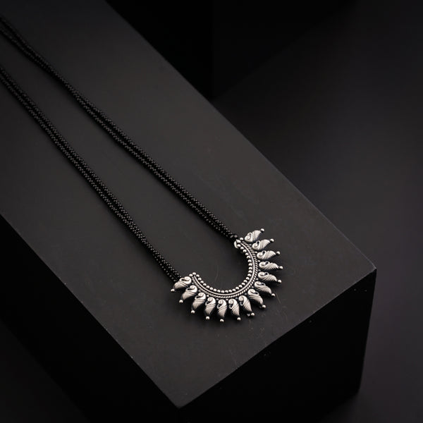 a pair of necklaces sitting on top of a black box