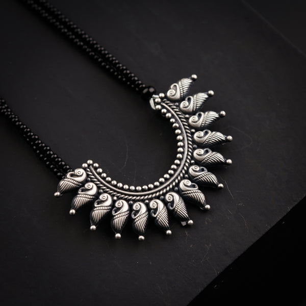 a necklace with a bird design on it