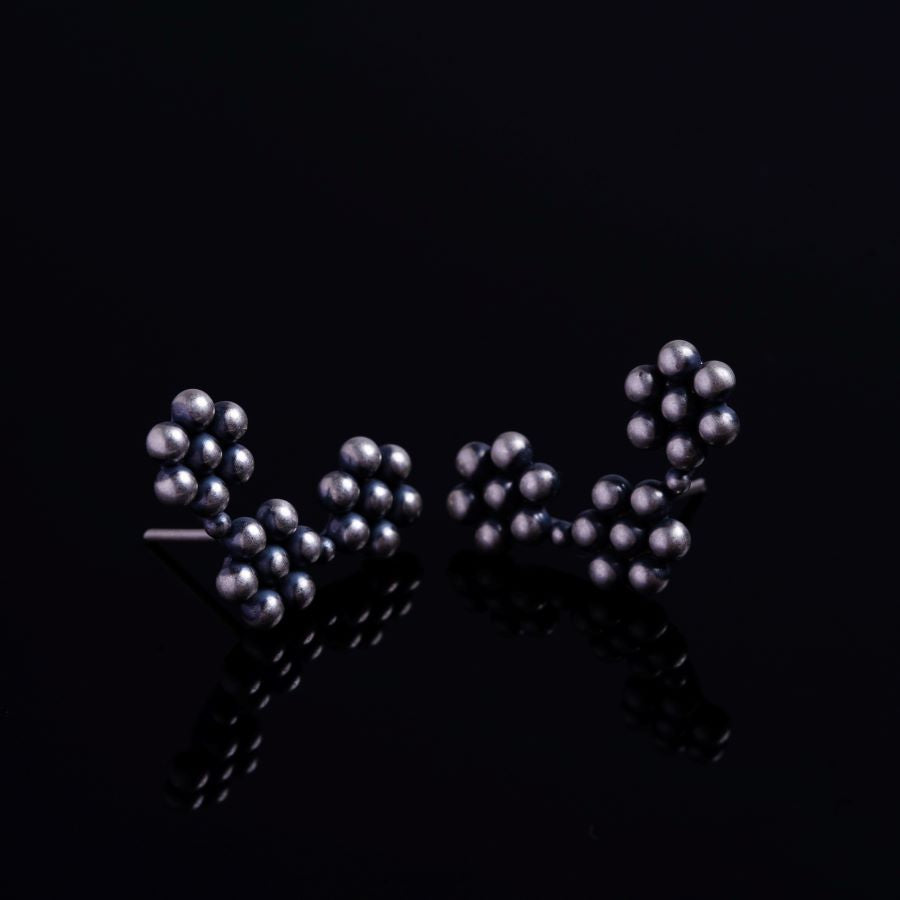 a pair of studs that are on a black surface