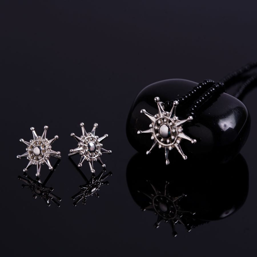 a pair of starburst earrings on a black background
