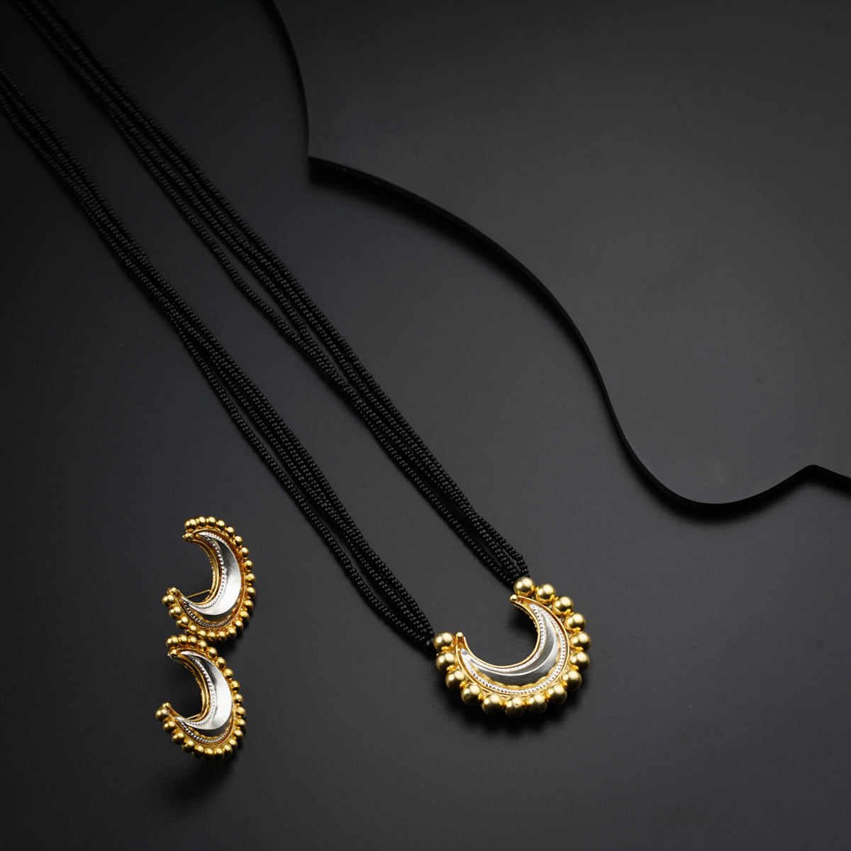 a couple of necklaces sitting on top of a table