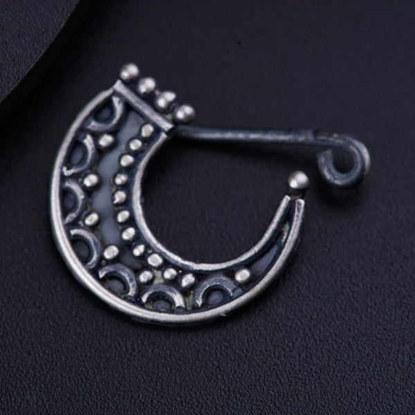 a close up of a metal object on a black surface