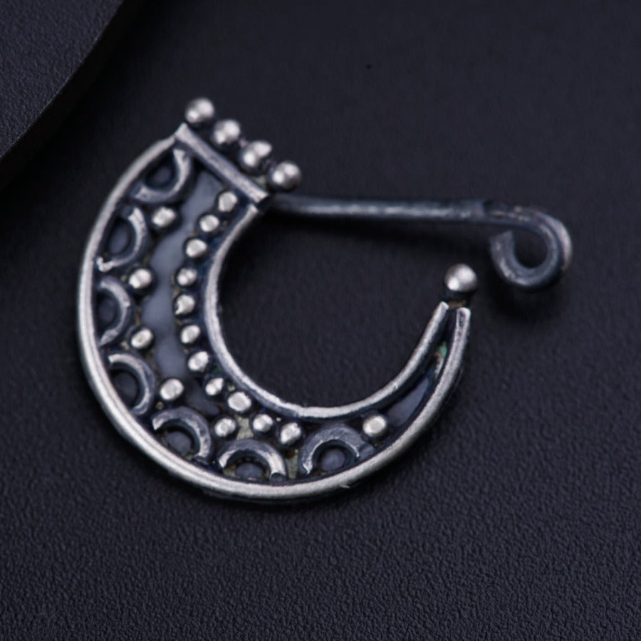 a close up of a metal object on a black surface