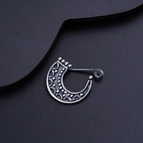a close up of a metal object on a black surface