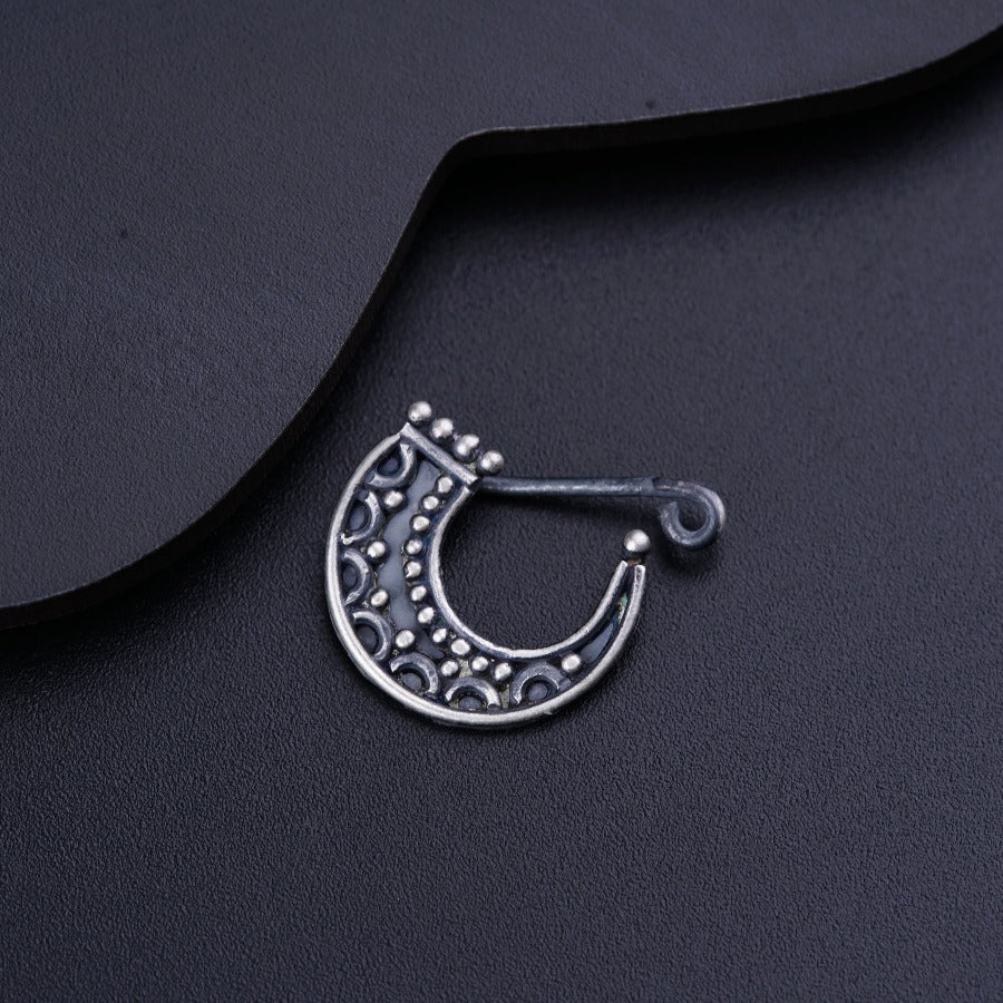 a close up of a metal object on a black surface
