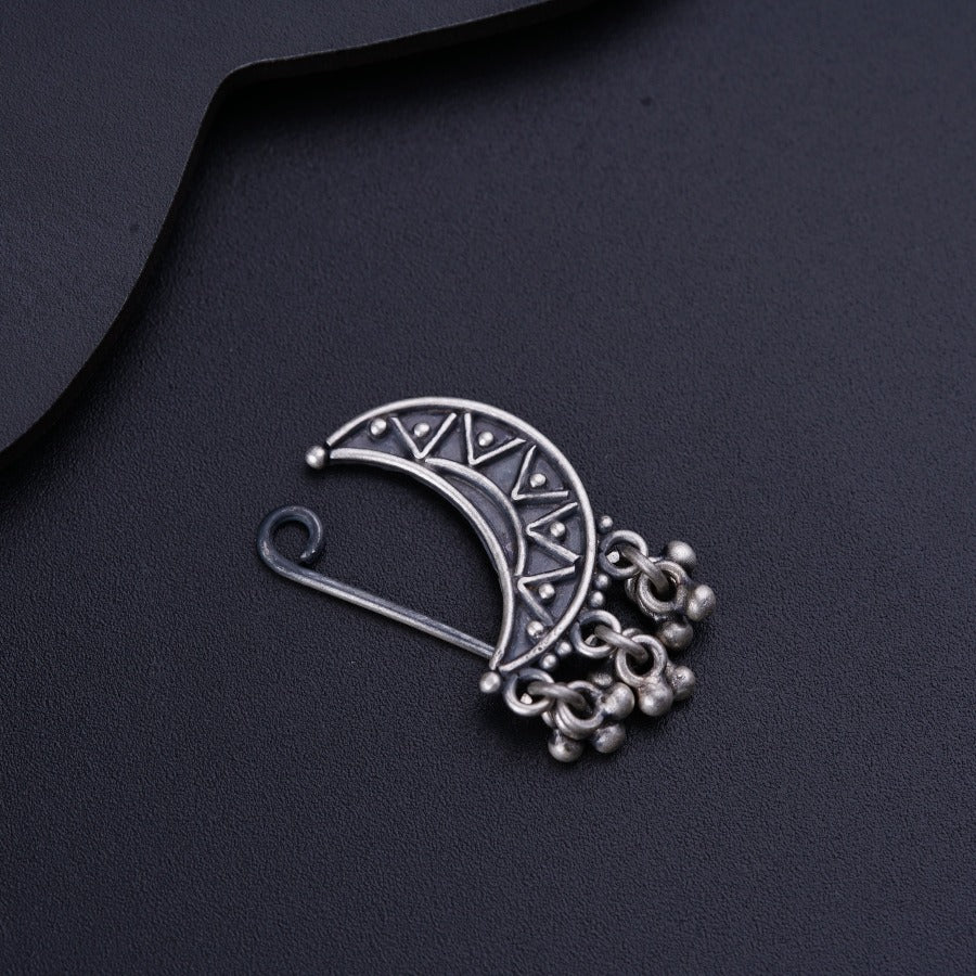 a close up of a metal object on a black surface