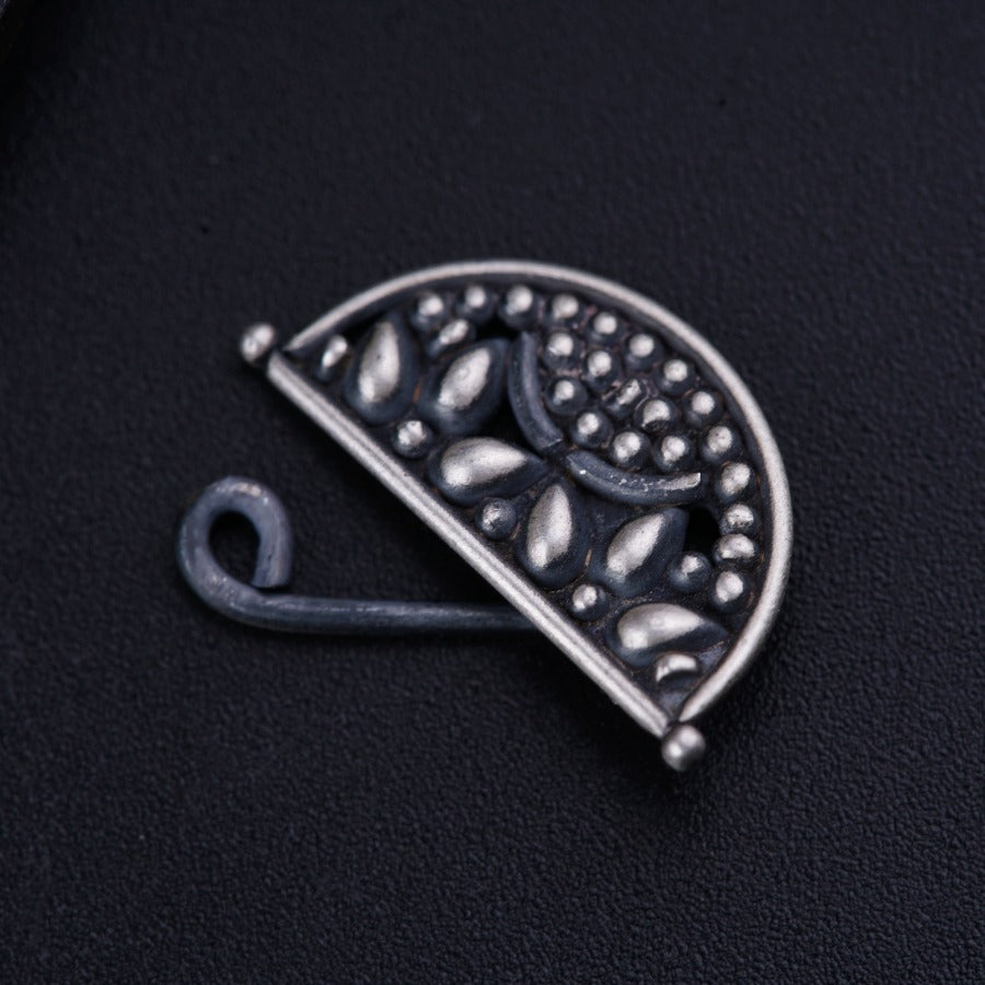 a close up of a metal object on a black surface