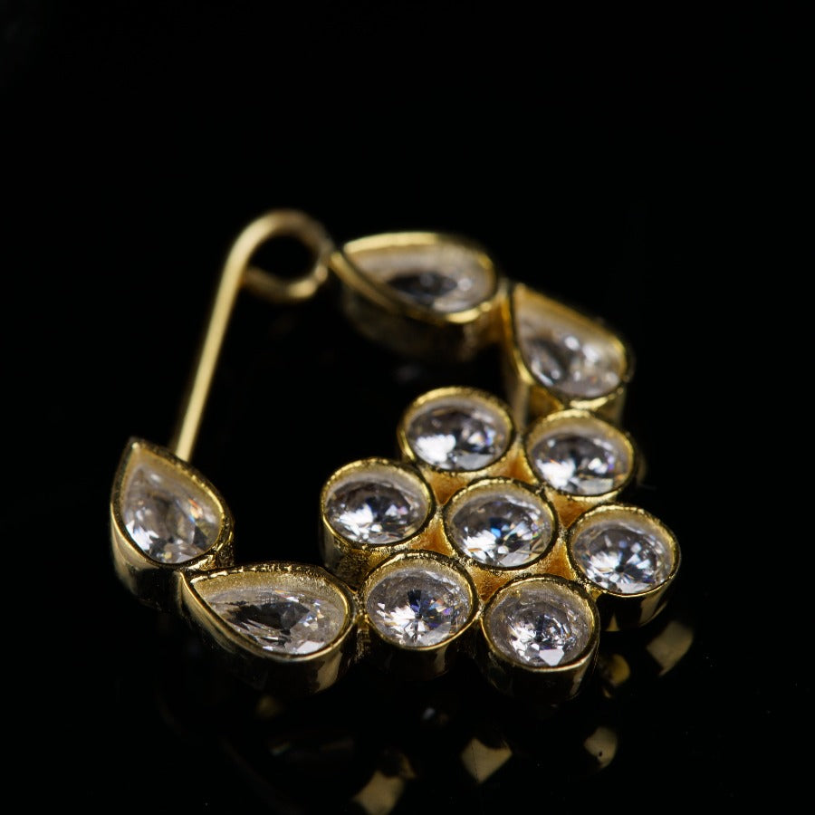 a close up of a pair of earrings on a black surface