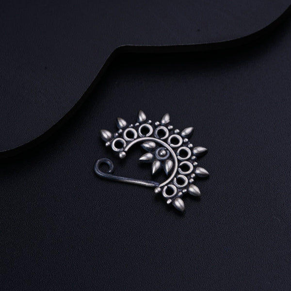 a close up of a metal object on a black surface