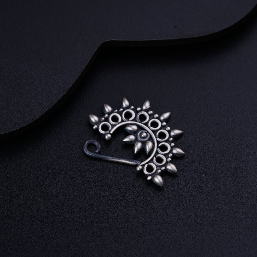 a close up of a metal object on a black surface