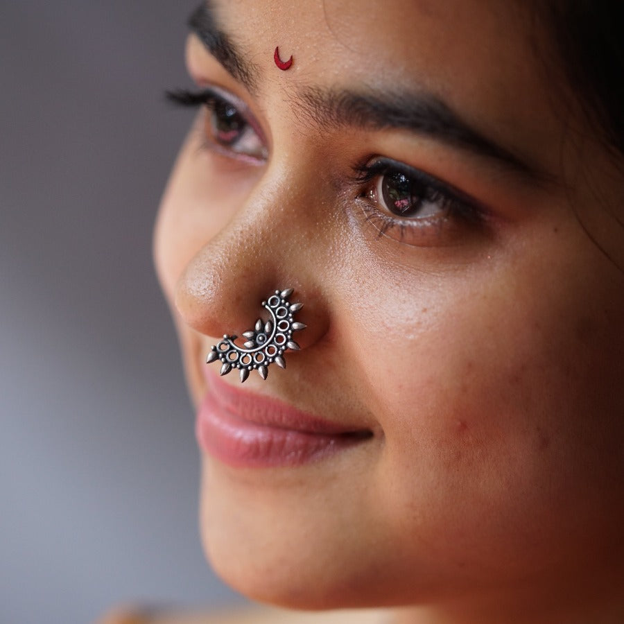 a close up of a woman with a nose ring