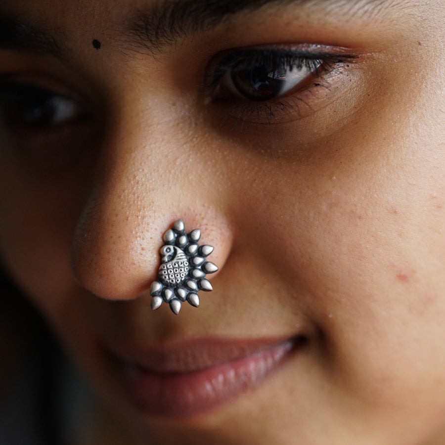 a close up of a person with a nose piercing