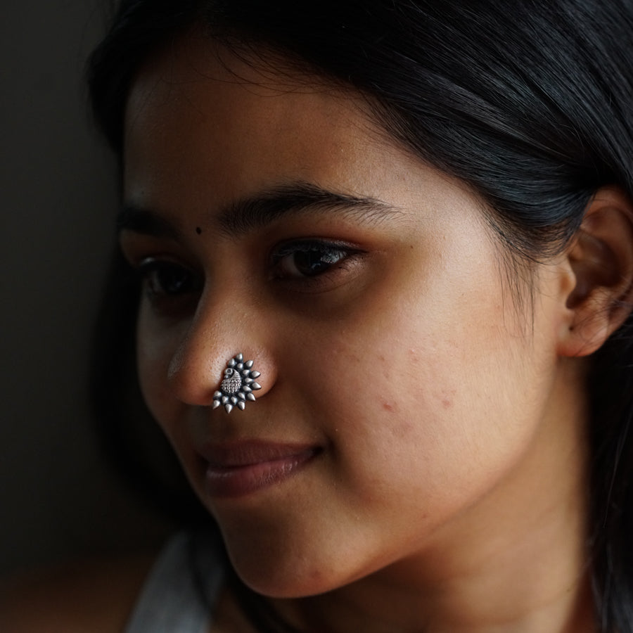 a close up of a person with a nose piercing