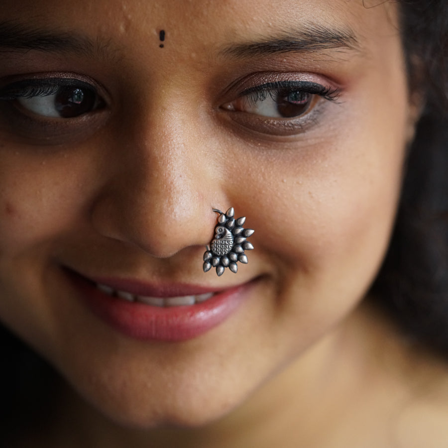 a close up of a woman with a nose piercing