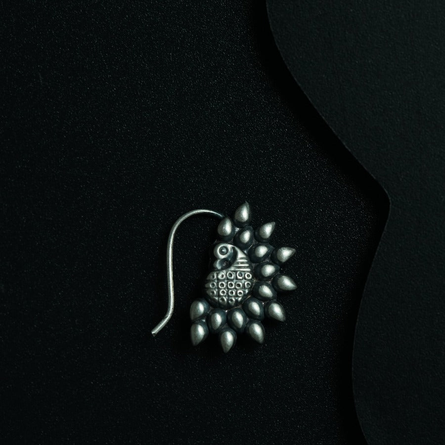 a close up of a brooch on a black background