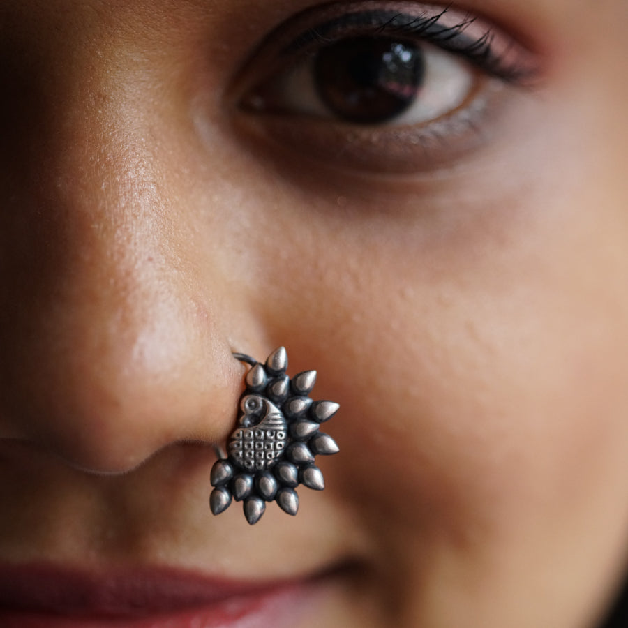 a close up of a person with a nose piercing