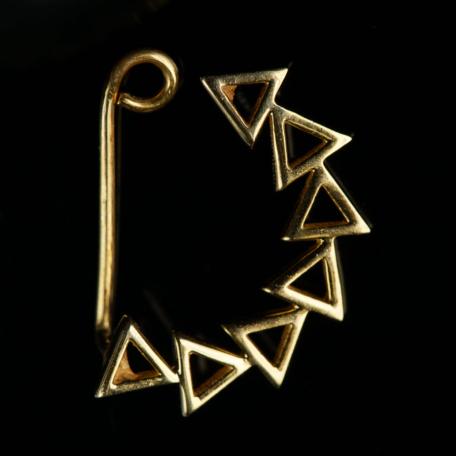 a close up of a metal object on a black background
