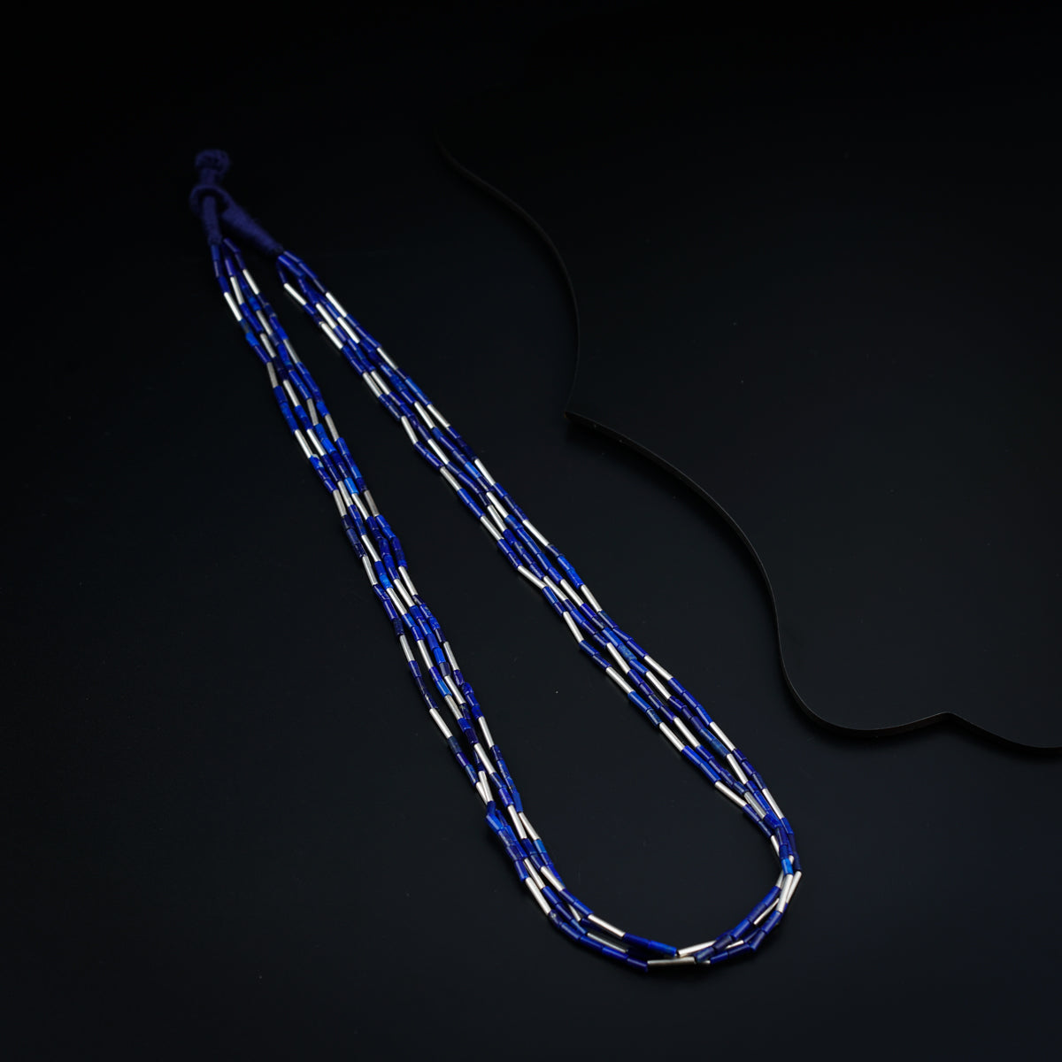 a blue and white lanyard on a black surface