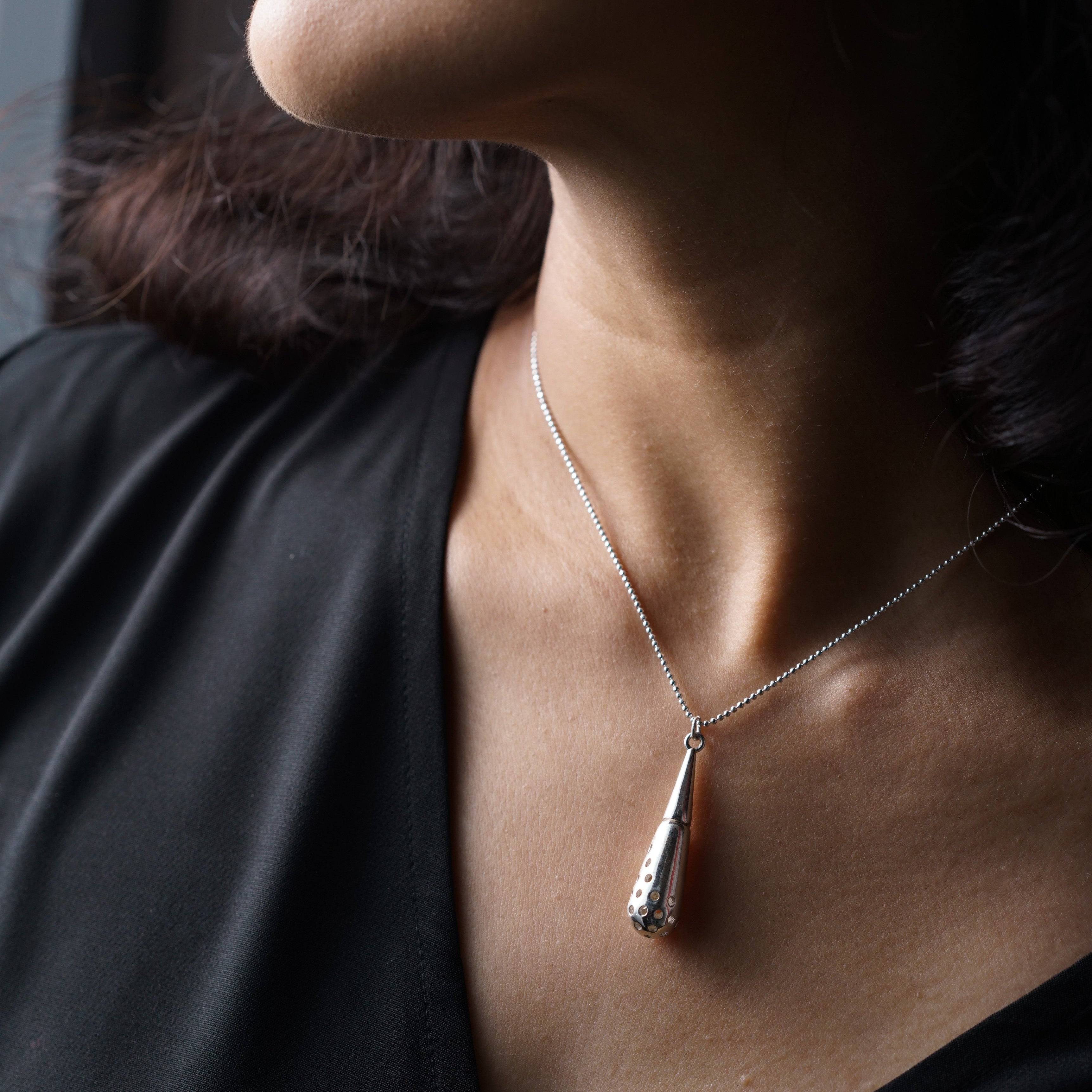 a close up of a woman wearing a necklace