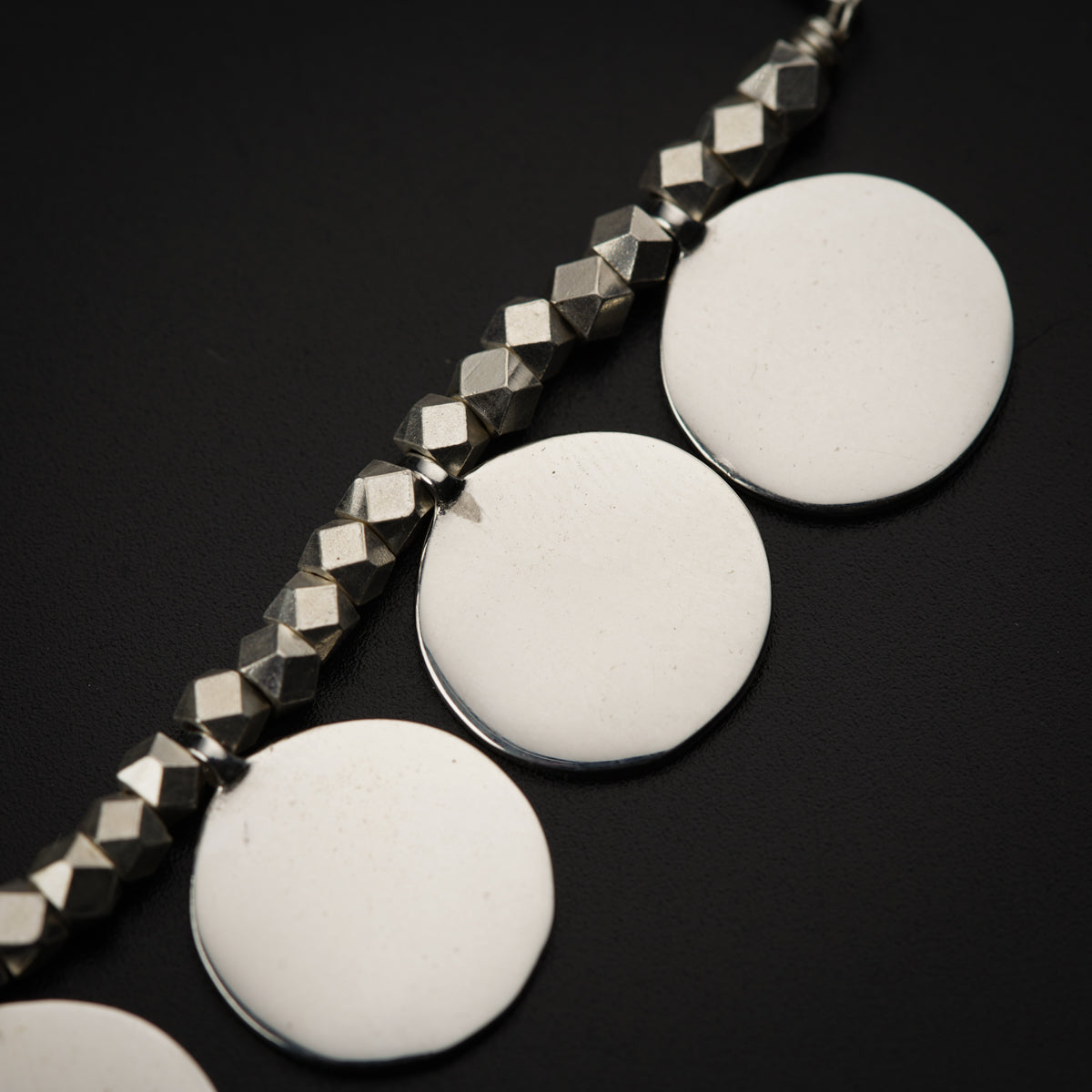 a close up of a metal chain with three circles on it