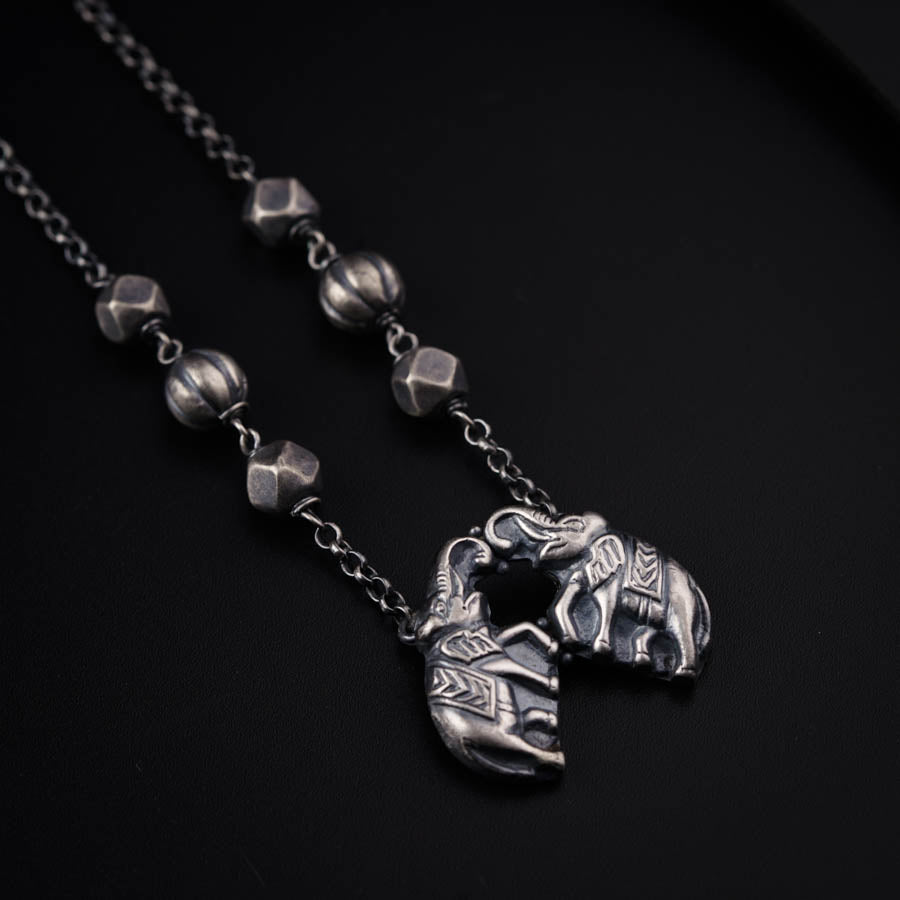 a necklace with an elephant head on it