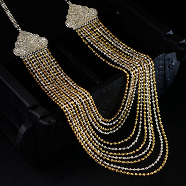 a pair of gold and silver necklaces on a black surface