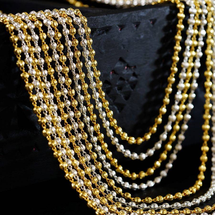 a close up of a gold and silver necklace