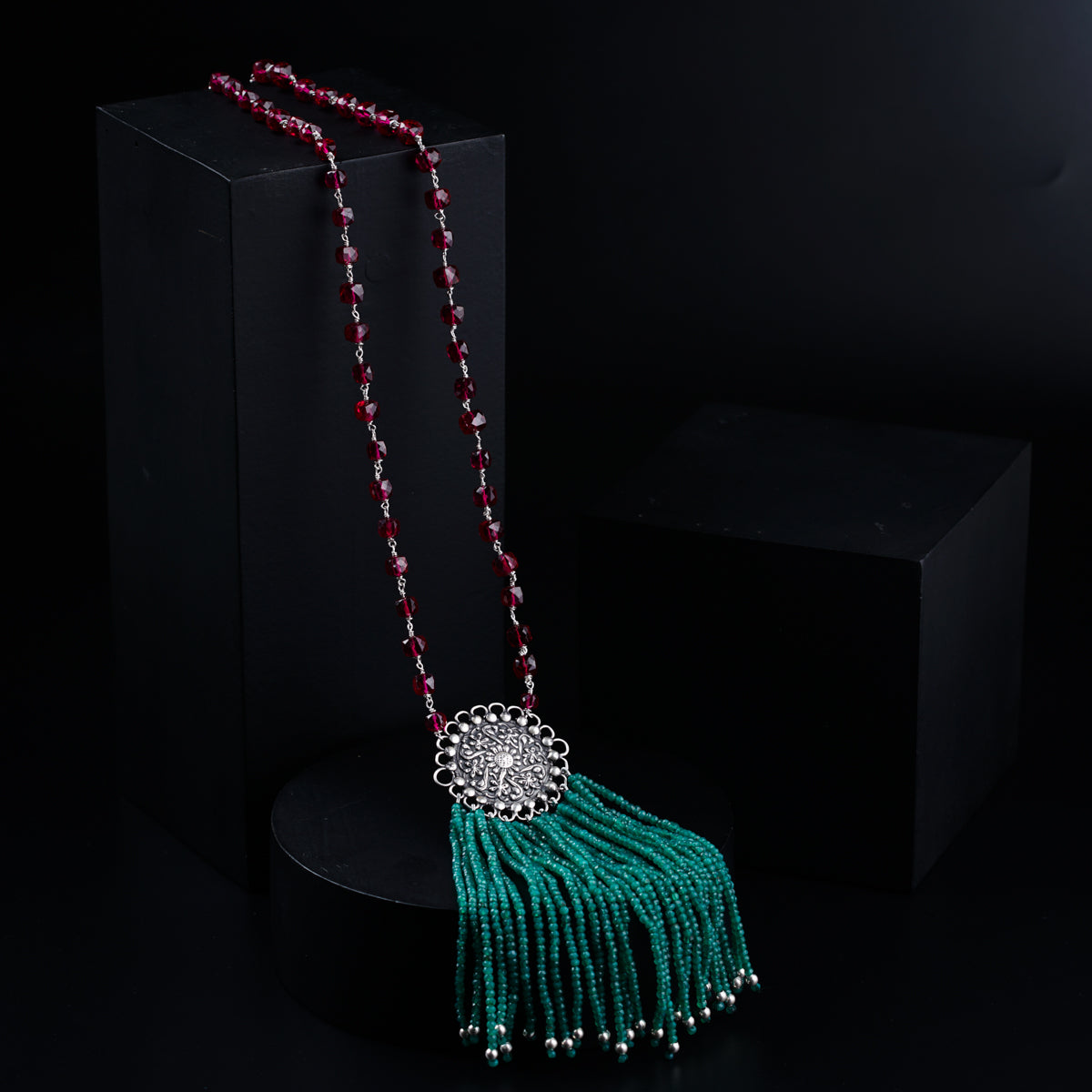 a tasseled necklace with beads and a tassel