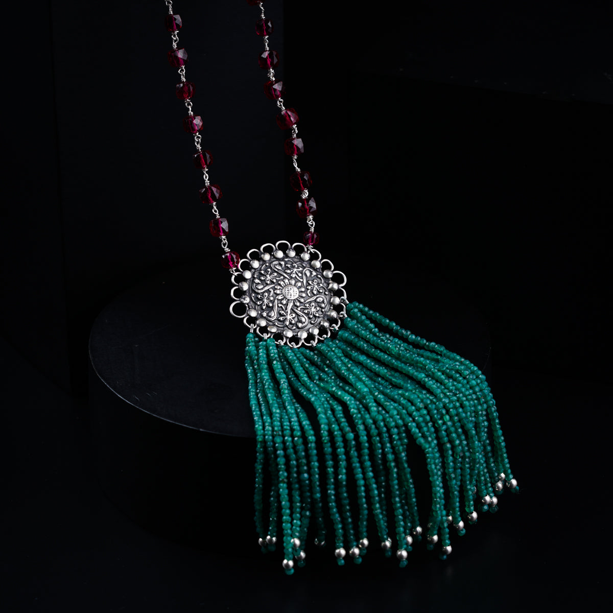 a necklace with beads and a tassel