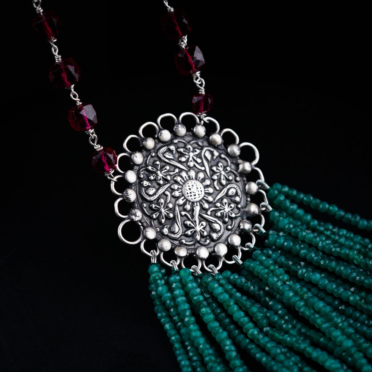 a close up of a necklace on a black background
