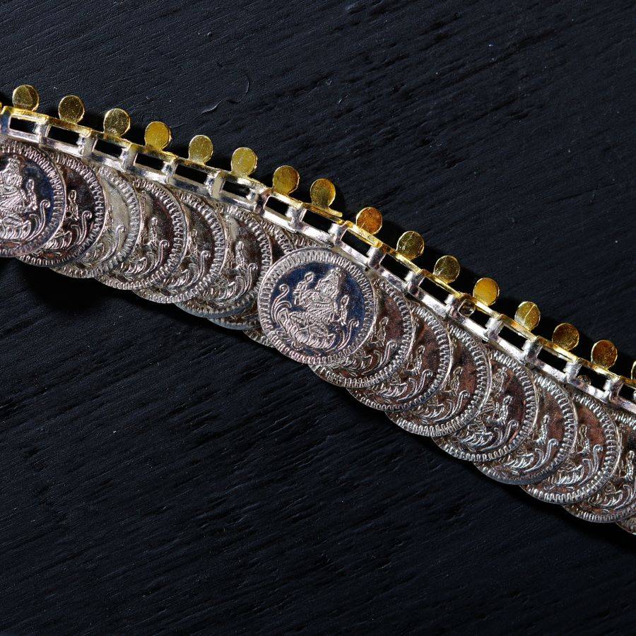 a close up of a metal chain on a black surface