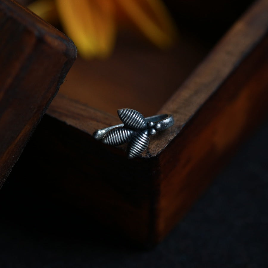 a close up of a wooden box with a flower in the background