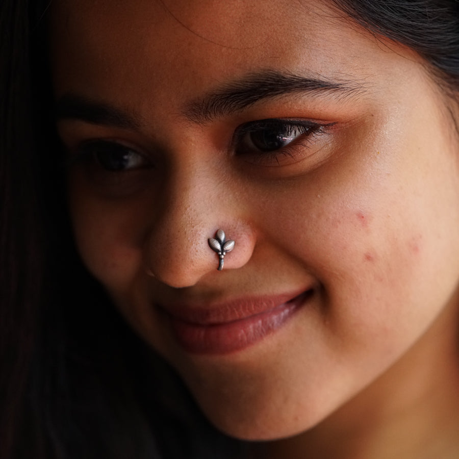 a close up of a person with a nose piercing