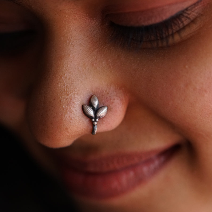 a close up of a person with a nose piercing