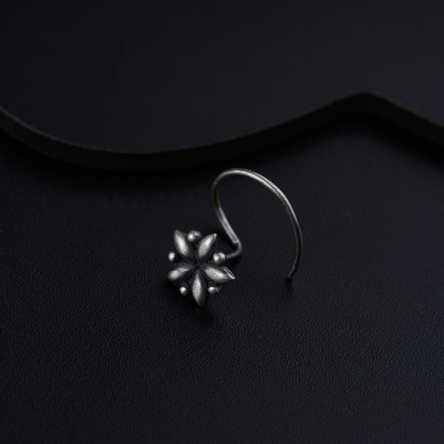a close up of a pair of earrings on a black surface